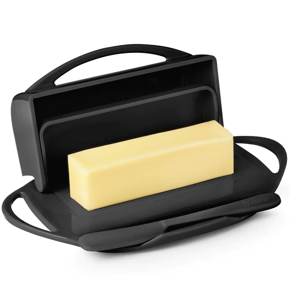 Picture depicts a black butter dish with two side handles, the lid up, and a matching knife. 