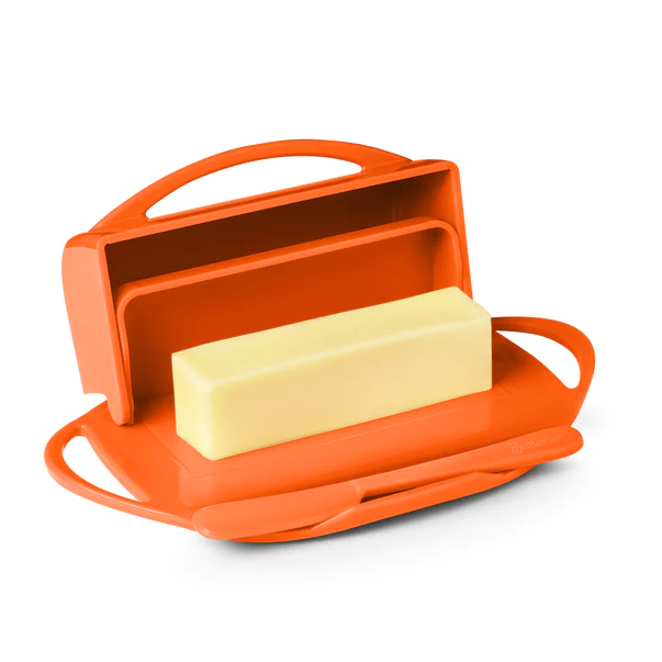 Picture depicts a orange butter dish with two side handles, the lid up, and a matching knife. 
