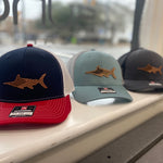 Load image into Gallery viewer, Three different styles of Marlin hat sitting in a window. 
