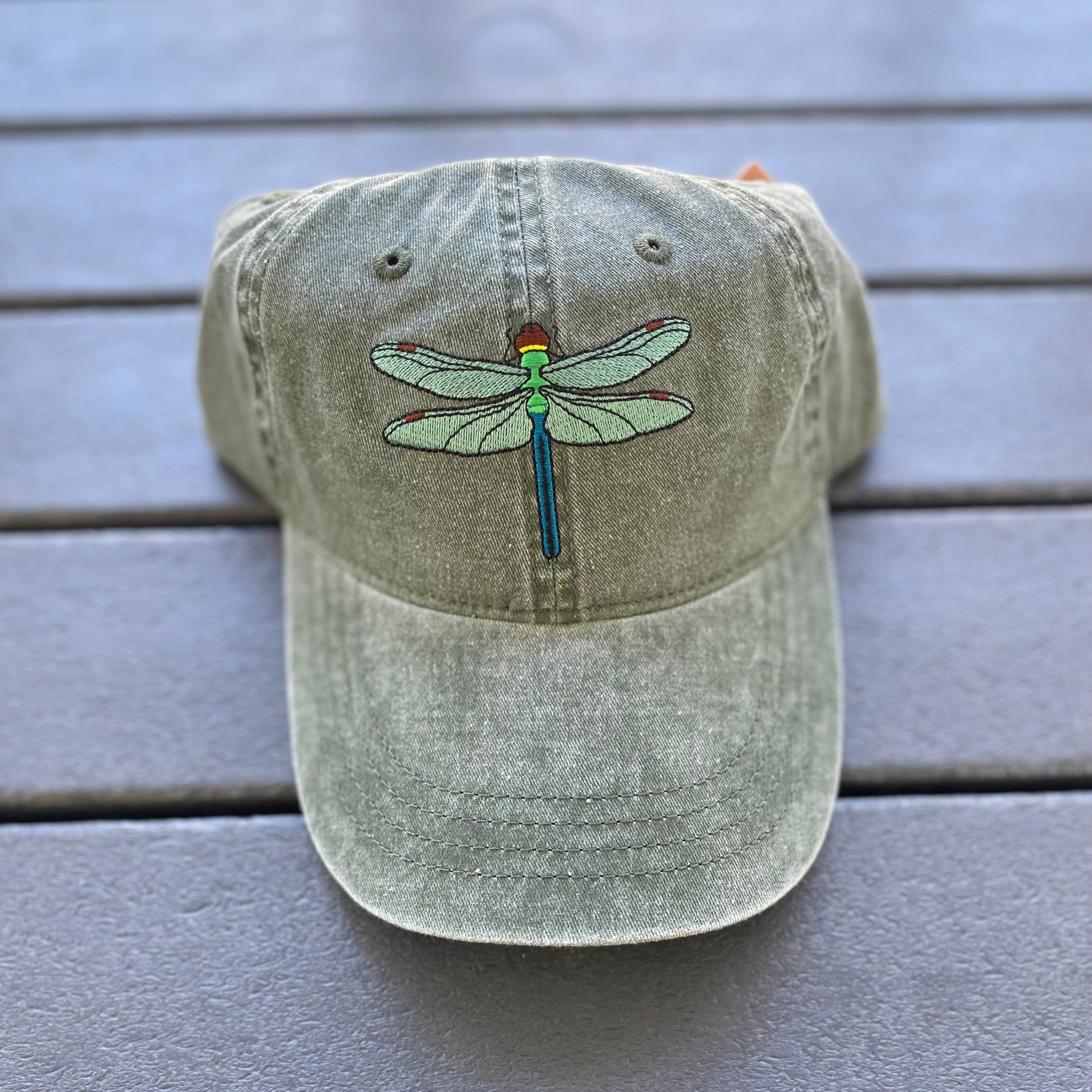 Olive green hat with Dragon fly embroidered on it. 