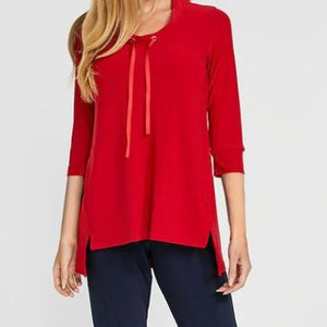 Front of sweatshirt is a red tunic style shirt. With a defined collar with red ribbon strings. Strings come out at the neck from a silver embellishment