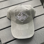 Load image into Gallery viewer, Light grey colored hat with anchor on it 
