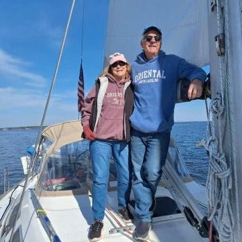 Oriental Mayor, Sally Belangia, enjoys a day on her sailboat while keeping warm in our Vintage Dragon sweatshirt