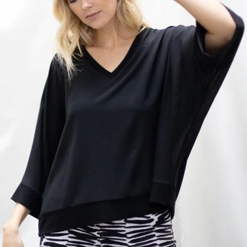 A loose fitting flowy black top with loose long sleeves