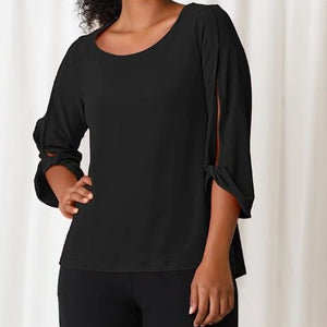 A simply yet elegant top. A solid black shirt with 3/4 length sleeves that are split down the center and appear to be tied.
