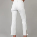 Load image into Gallery viewer, High rise bootcut jeans in a crisp white color with a raw hem and side slit detail at the ankle
