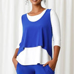 Load image into Gallery viewer, Front of shirt. Has a cropped, hi-low hem line. Shirt is a bright blue. 

