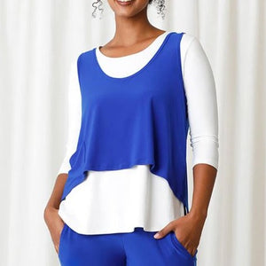 Front of shirt. Has a cropped, hi-low hem line. Shirt is a bright blue. 
